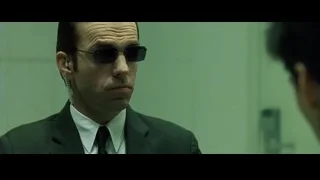 man in suit and sunglasses in green room — The Matrix
