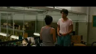 two young men in cluttered workspace — The Dictator