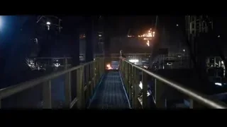 Man walking in dark industrial area with fire — Iron Man 3