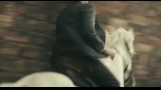 Person in suit riding white horse — Peaky Blinders