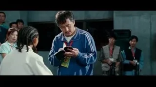 Man reading book to girl in front of crowd — The Karate Kid