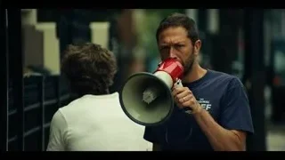 two men with megaphone on street — The Bear