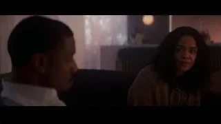 Man and woman on couch in dimly lit room — Creed 3