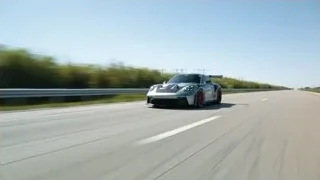 Silver Porsche driving on highway with trees — Sports Cars