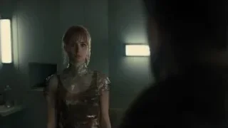 young woman standing in dimly lit room — Blade Runner 2049