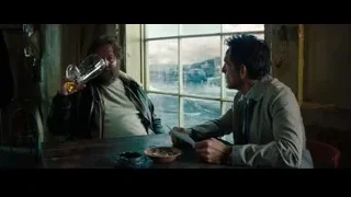 two men pouring whiskey at table in dimly lit room — The Secret Life of Walter Mitty