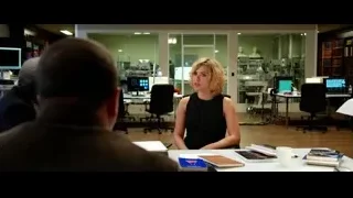 woman conversing with two men in bright office — Lucy