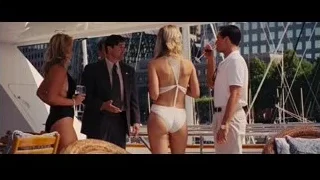 four people conversing on yacht — The Wolf Of Wall Street