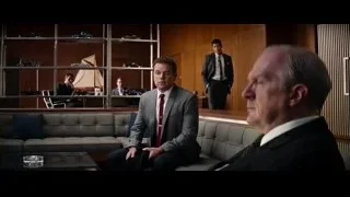 two men in suits in room with window — Ford v Ferrari