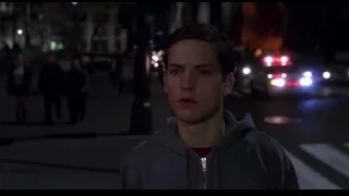 young man standing on busy street at night — Spider Man
