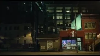 city street at night with tall buildings — The Bear